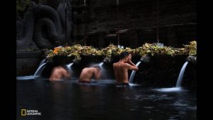 men-take-part-in-a-bathing-ritual-in-the-tirta-empul-temple-in-bali-the-temples-fresh-spring-water-is-believed-to-be-holy-water-t