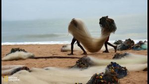 two-young-anglers-in-greater-accra-ghana-carry-fishing-nets-to-their-boat